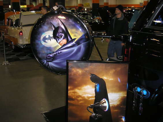 Large sphere with Batman airbrush art, framed Batman artwork, and a black SUV