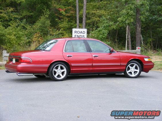 Red 1997 Mercury Grand Marquis sedan, side view