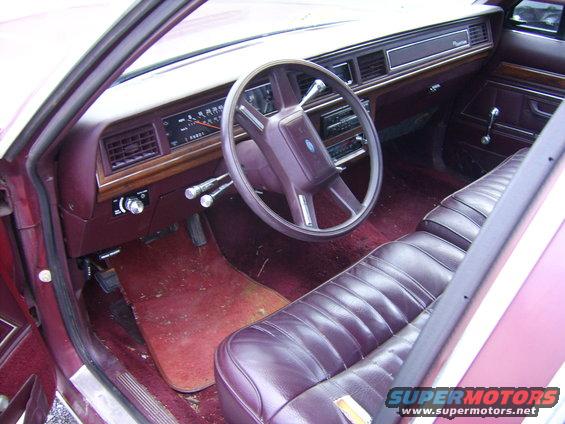 1988 Ford Crown Victoria LTD interior with burgundy seats and dashboard. Steering wheel and radio visible