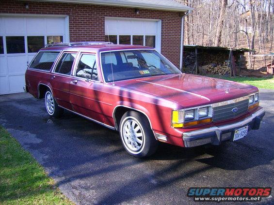 1988 Ford Crown Victoria LTD wagon parked in driveway. Red paint, chrome trim, whitewall tires