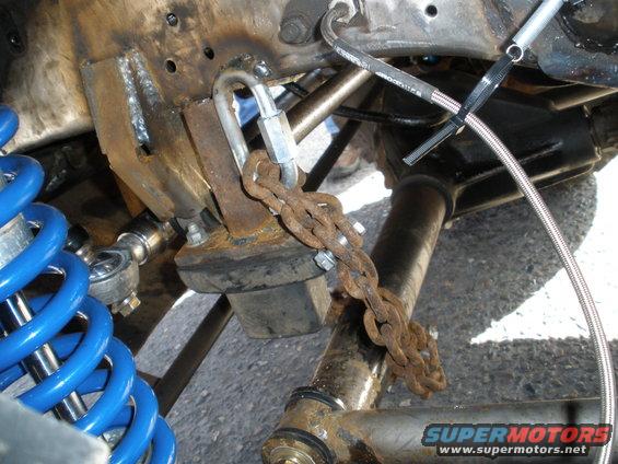 Modified suspension part with blue coilover and rusty chain