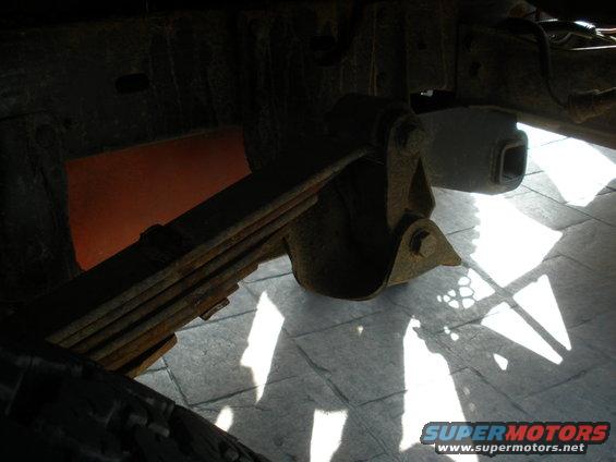 Leaf spring and suspension bracket on a vehicle frame