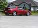 1993 Mazda MX-3 - This 1993 Mazda MX-3 coupe features a distinctive rear spoiler and sporty alloy wheels, captured in a side profile view.