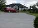 1993 Mazda MX-3 - A red 1993 Mazda MX-3 is parked on a concrete driveway with a house in the background.
