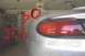 1998 Ford Taurus - A red arrow and text overlay question the position of the car's antenna, with another vehicle partially visible in the background.
