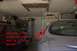 1998 Ford Taurus - A silver 1998 Ford Taurus is parked in a garage next to a red car, with tools and a ladder visible in the background.