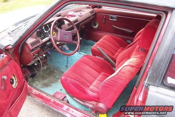 Interior of a 1983 Honda Accord with red seats and dashboard