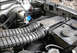 1995 Ford Bronco - Close-up view of engine bay components including air intake hoses and brake fluid reservoir.
