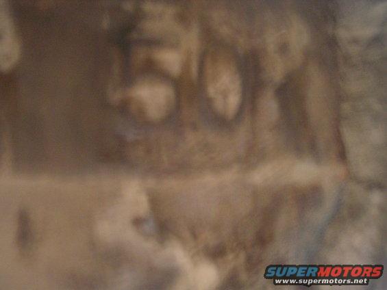 Close-up of a brown engine part with the number 50 etched into it