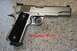 2007 Nissan Titan - A Springfield Armory 1911A1 pistol is shown in a close-up view.