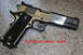 2007 Nissan Titan - Springfield Armory pistol with black grip and silver slide shown on a speckled surface.
