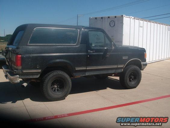 Side view of black 1989 Ford Bronco with aftermarket wheels