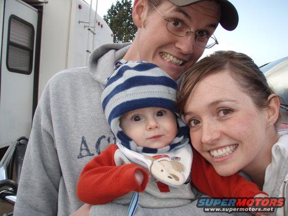 Family posing for a selfie with a baby in front of a trailer