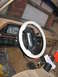 1987 Ford Bronco - The dashboard and steering wheel of a vehicle are visible, with a garage door reflected in the windshield.