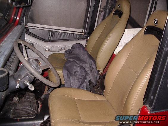 Interior of a 1987 Jeep YJ showing tan seats and steering wheel
