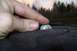 1976 GMC Sierra 2500 - Checking tire tread depth with a coin in an outdoor setting.