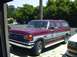 1989 Ford Bronco - This two-tone Ford Bronco SUV is parked in a driveway on a sunny day.