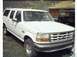 1995 Ford Bronco - White 1995 Ford Bronco parked outdoors, showing its front grille and 3/4 view.