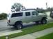 1995 Ford Bronco - This lifted 1995 Ford Bronco SUV is shown from a 3/4 front angle, parked on a suburban street.