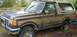 1988 Ford Bronco - This Ford Bronco appears to be from the late 1980s, possibly a 1987 model, with a flat tire and some rust.