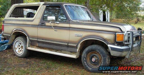 Tan and brown 1988 Ford Bronco with brush guard parked outdoors