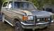 1988 Ford Bronco - This older model Ford Bronco is parked outdoors with a brush guard and distinctive two-tone paint scheme.