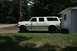 1991 Ford C-350 (Centurion Conversions) - This 1991 Ford C-350 Centurion Conversions extended cab pickup truck is seen parked on a grassy area next to a white building.
