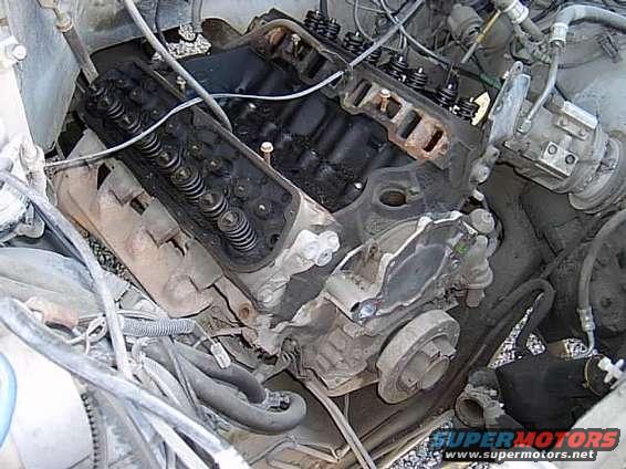 Ford V8 engine with valve covers removed, showing pushrods and springs