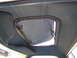 1972 Ford Ranchero - The interior of a vehicle shows a sunroof with visible latches and a blue sun visor.