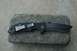 1991 Ford Bronco - A black folding knife with a partially serrated blade is placed on a gray brick.
