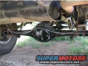 Rear axle assembly and exhaust pipe on a vehicle, with SuperMotors.net logo visible