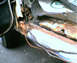 1990 Ford Bronco - Close-up of a rusted vehicle floor pan with visible wiring.