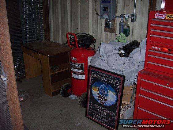 Red Husky air compressor and red Eddlebrock tool chest in a garage