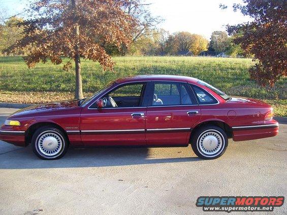 Red 1994 Ford Crown Victoria sedan, side view