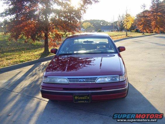 Front view of a red sedan with a chrome grille and a license plate that says Stovall's