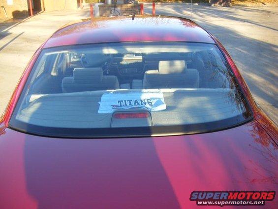 Red sedan rear interior with Titans towel on back window