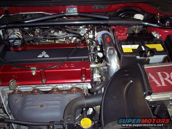 Engine bay with red valve cover and Mitsubishi logo