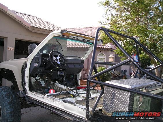 Interior of a 1986 Toyota Hilux with roll cage and removed doors