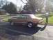 1977 Ford Mustang II - A brown 1977 Ford Mustang II coupe is seen from the side in a suburban setting.