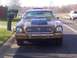 1977 Ford Mustang II - Front view of a 1977 Ford Mustang II, a prominent hood scoop and custom grille.