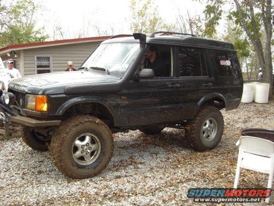 Black Land Rover Discovery with snorkel and off-road tires