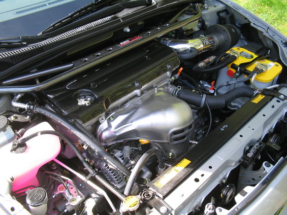 Engine bay with aftermarket intake and carbon fiber engine cover