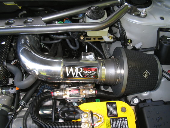 Engine bay with chrome intake system and yellow battery