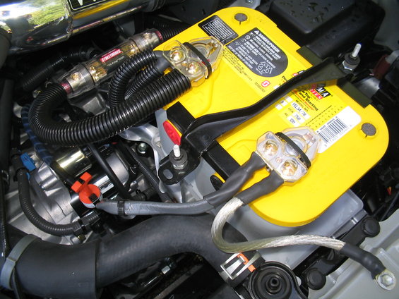 Engine bay with yellow Optima battery and custom wiring