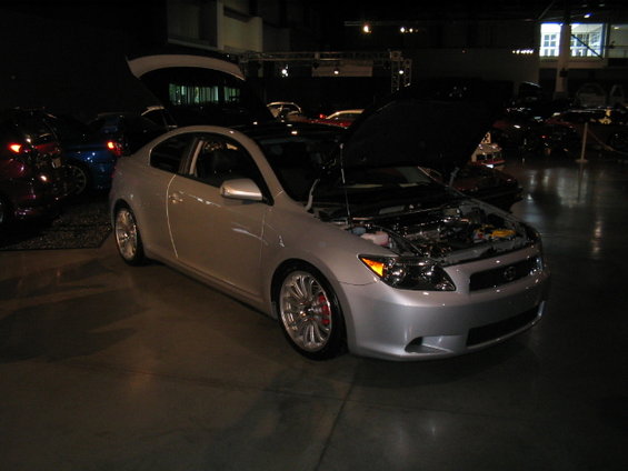 Silver 2005 Scion tC coupe, front 3/4 view, hood open revealing engine