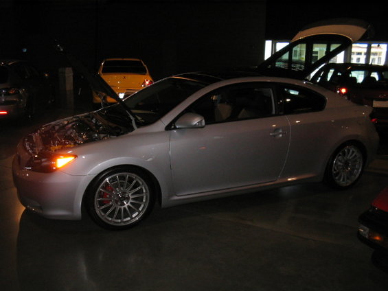 Silver 2005 Scion tC coupe with hood and trunk open, parked indoors