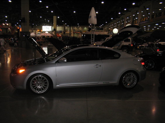 Silver 2005 Scion tC coupe with hood open at a car show