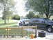 2000 Ford Excursion - A dark 2000 Ford Excursion is seen here towing a light blue SUV on a trailer in a driveway.