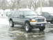 2000 Ford Excursion - This lifted 2000 Ford Excursion is parked in a lot with snow and ice on the ground.