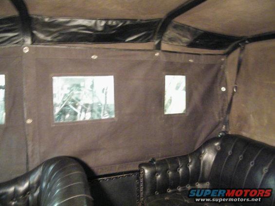1915 Ford Model T interior showing tufted leather seats and fabric roof with small windows